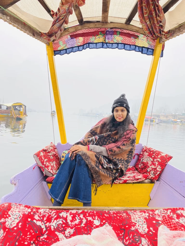 A lady sitting on a Houseboat in Keshmir